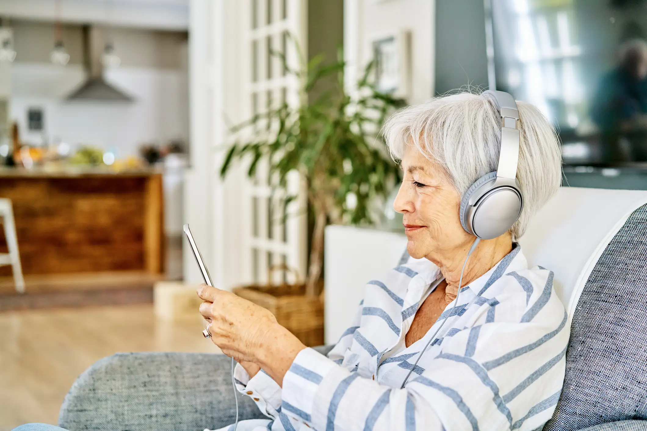 Senior woman listening to an audiobook
