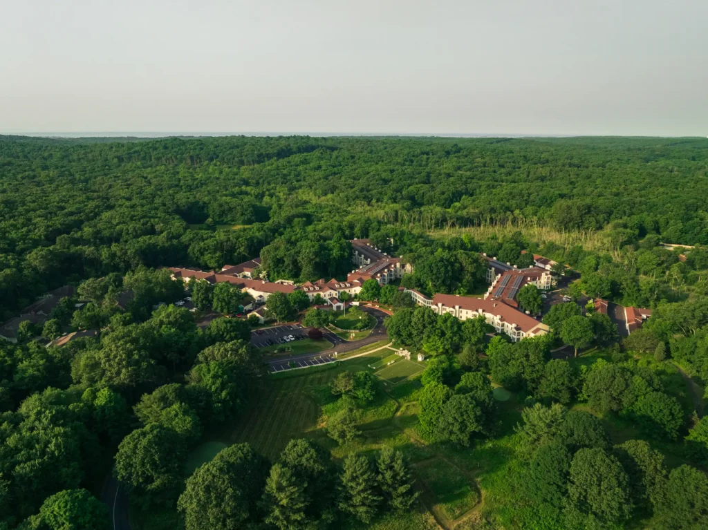 aerial view of Essex Meadows showing acres of trees, green grass and the preservice