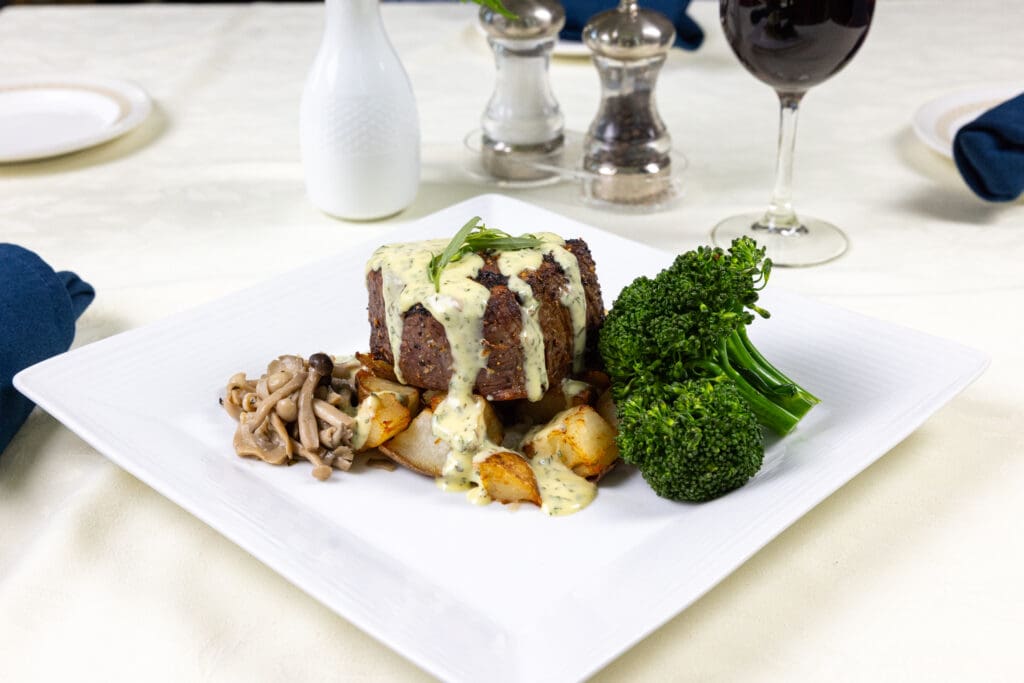 A dinner, filet mignon with cream sauce, mushrooms, broccoli, showcasing resident's favorite meals at Essex Meadows in CT.