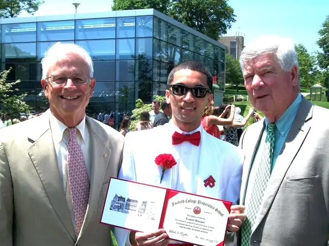Michael Dowley, left, and Julius Friese, both graduates of Fairfield College Preparatory School, attending the graduation at Fairfield of Saint Martin de Porres Academy graduate Ezequiel Velasquez.