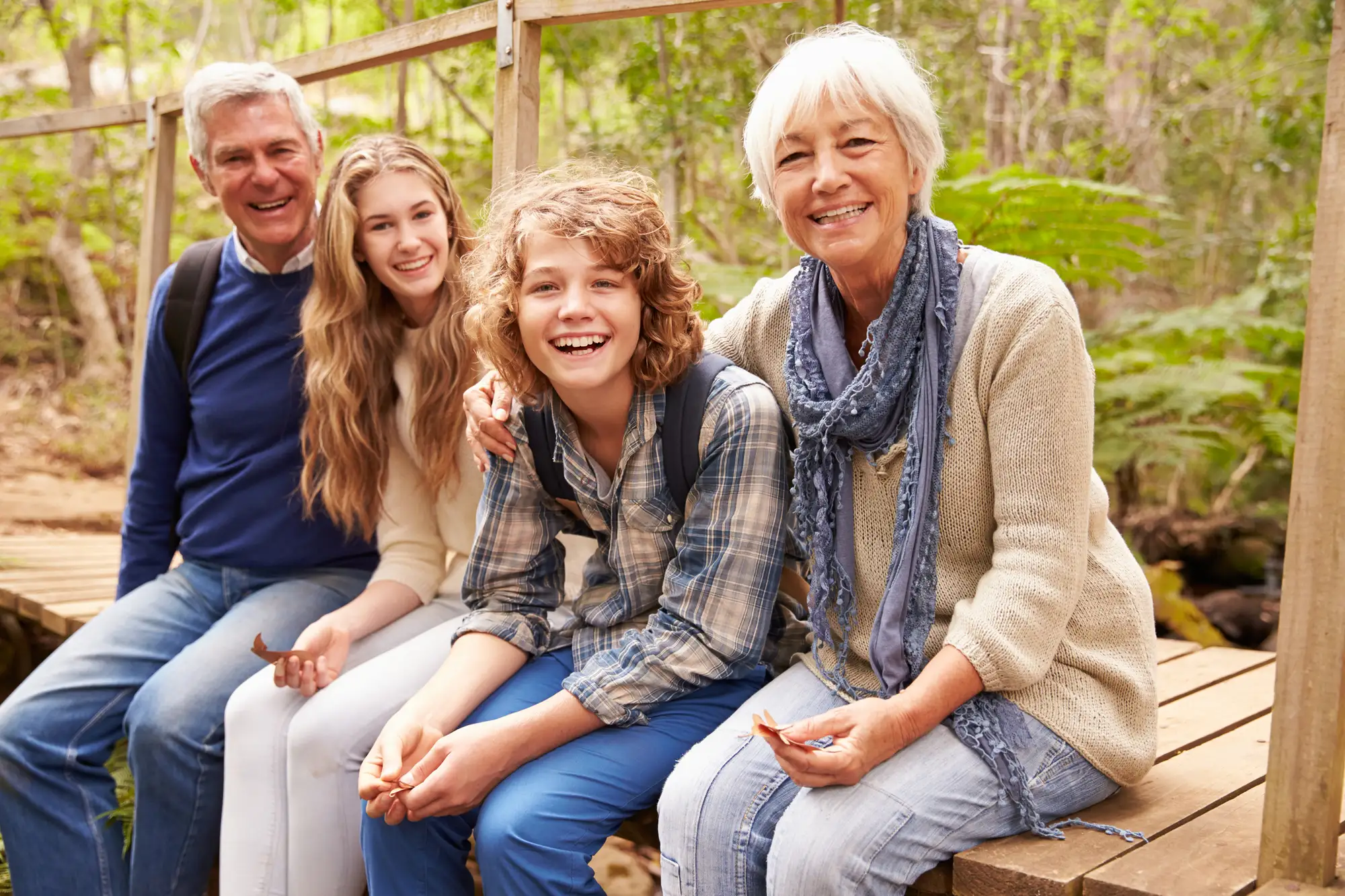 grandparents and grandkids sitting outside, enjoying multigenerational summer activities in Essex, CT at Essex Meadows.