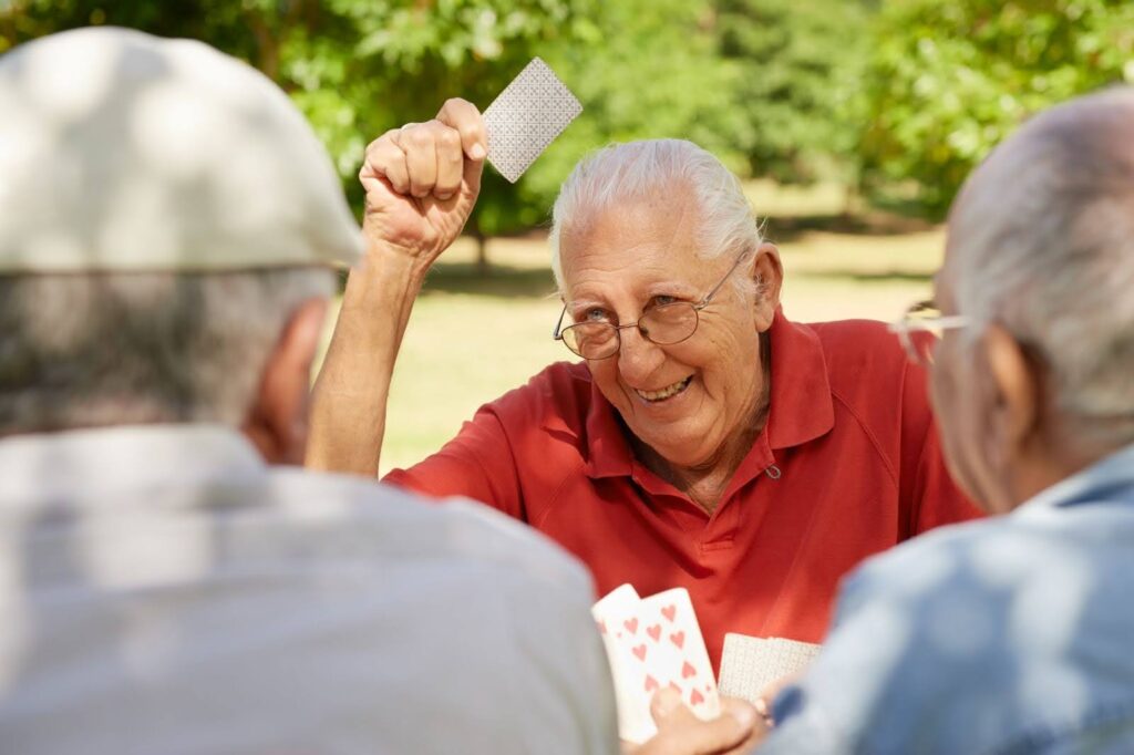 Senior men playing cards and laughing
