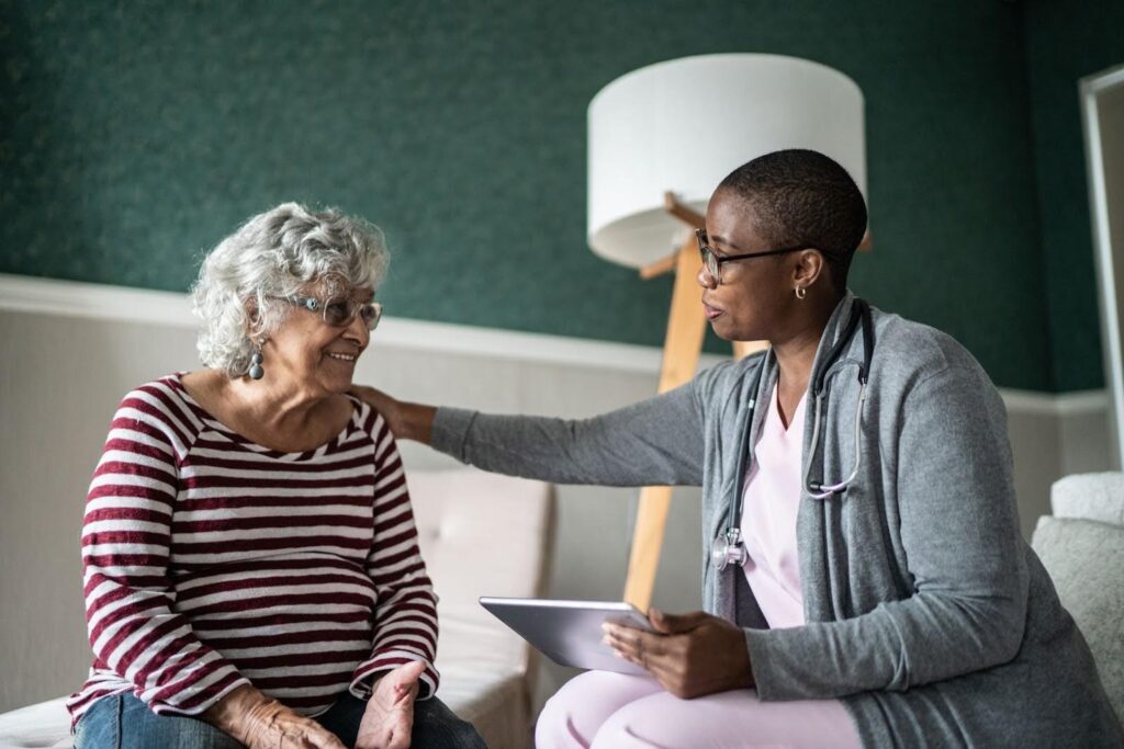 Skilled nurse talking with a senior woman